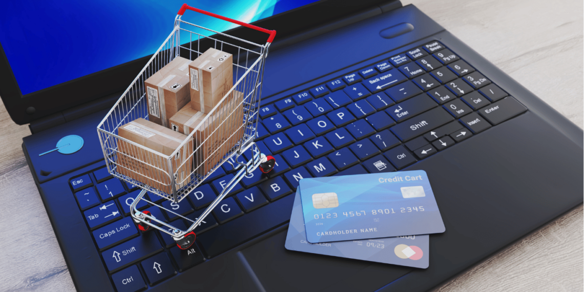 As Melhores Lojas Digitais de Jogos para PC e Video Games! 1 Carrinho de compras sobre um teclado de laptop, simbolizando compras digitais de jogos para PC e consoles.