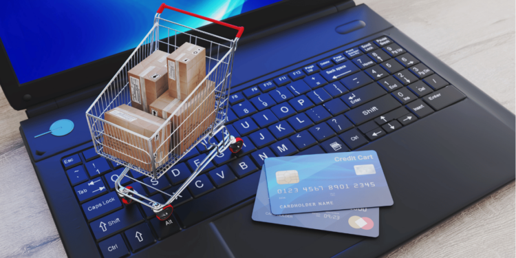 As Melhores Lojas Digitais de Jogos para PC e Video Games! 2 Carrinho de compras sobre um teclado de laptop, simbolizando compras digitais de jogos para PC e consoles.